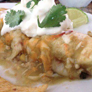 A close up of a plate of food, with Enchilada and Chicken