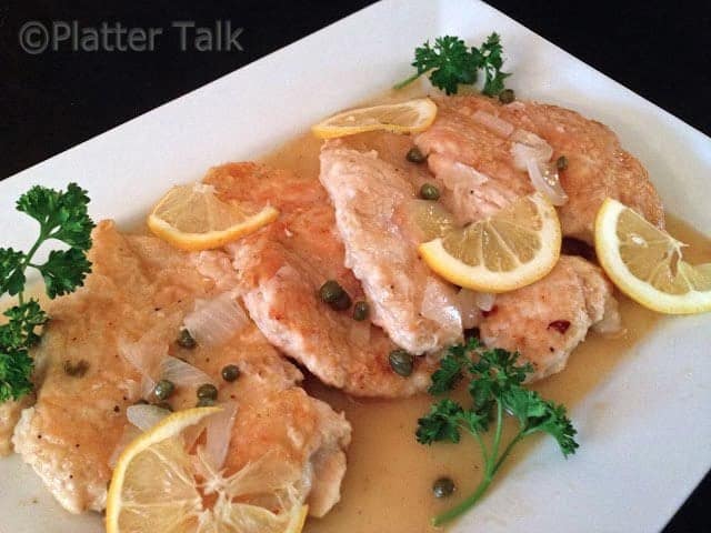 A plate of food with chicken piccata