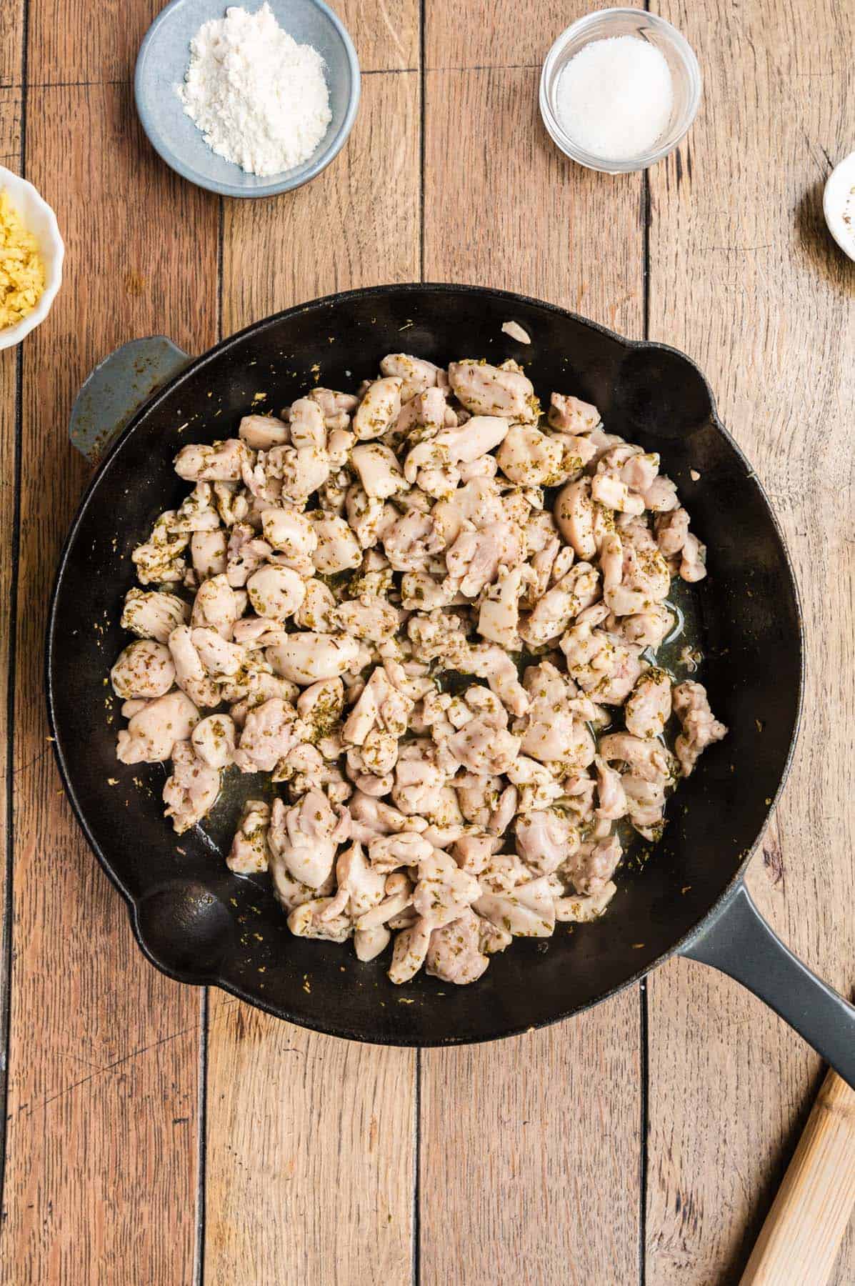 Some cooked shredded chicken in a skillet.