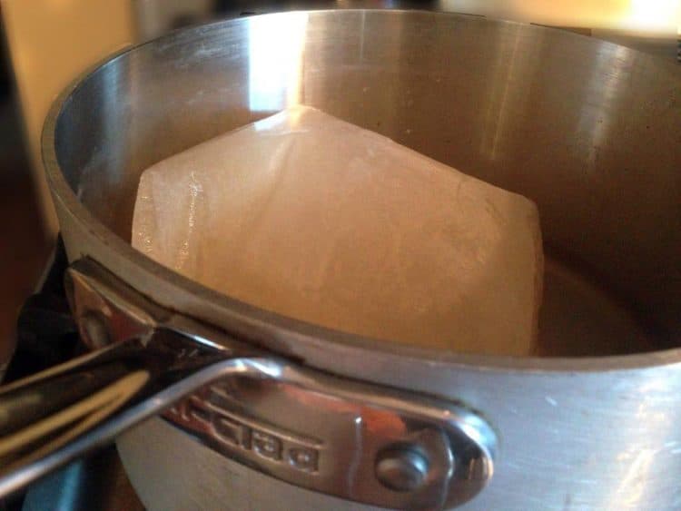 Frozen broth in a sauce pan