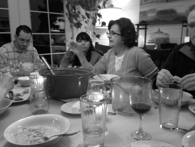 A group of people sitting at a table at home