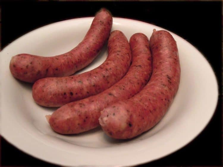 A close up of food on a plate, with Sausage and Kielbasa