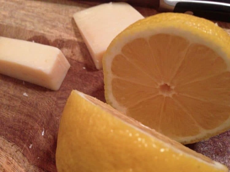 lemon and cheese on a cutting board