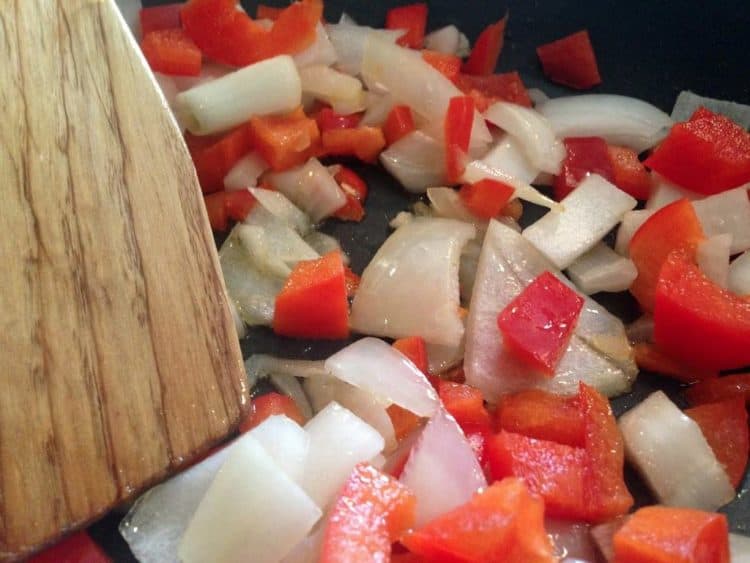 Chopped onion and red pepper in a skillet