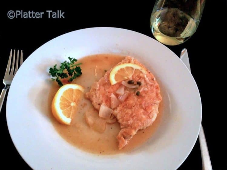 A plate of chicken piccata