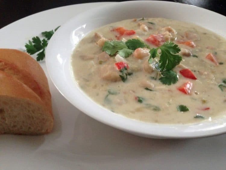 A bowl of white chicken chili on a plate