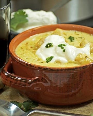 A bowl of food on a table, with Chicken