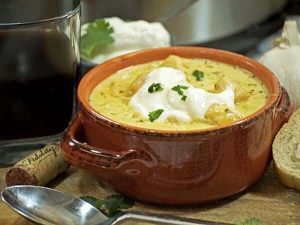 A bowl of food on a table, with Chicken