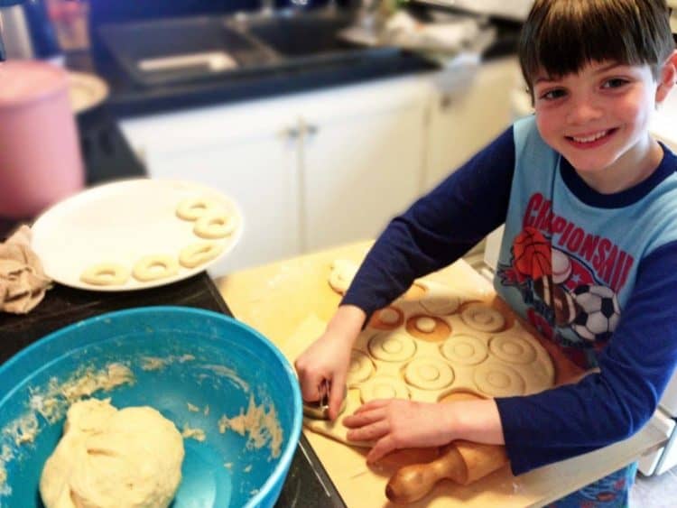 A little boy sitting at a table making Fasnacht 