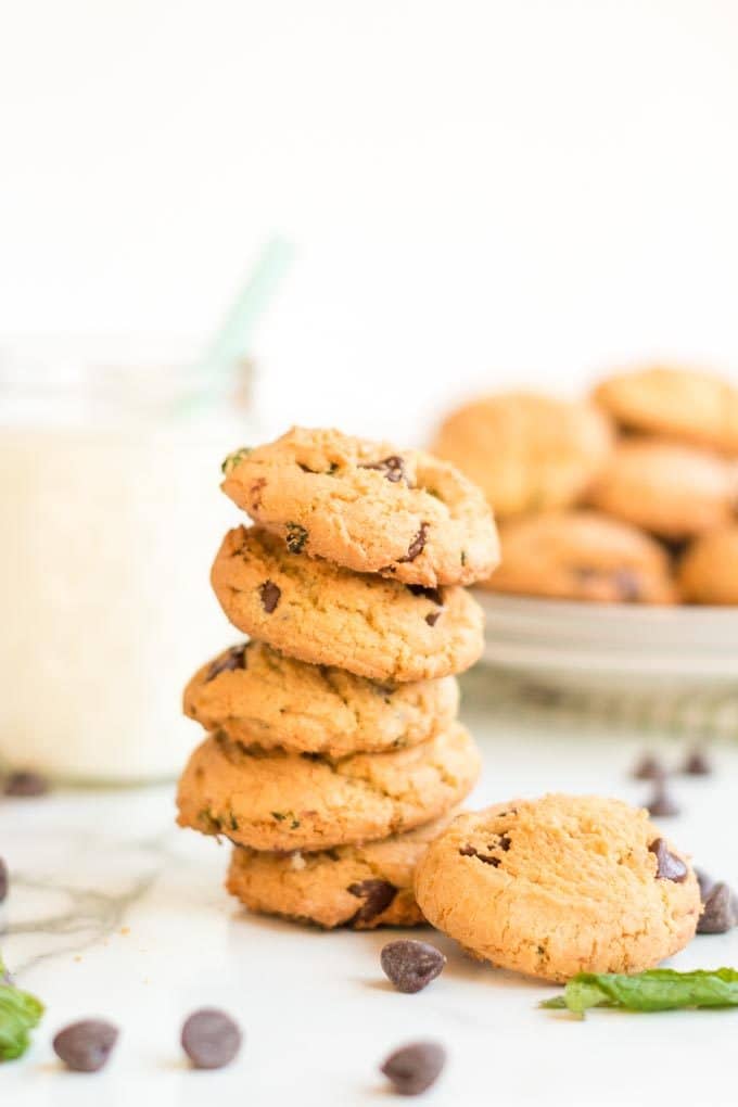 Stack of chocolate mint cooies with pitcher of milk.