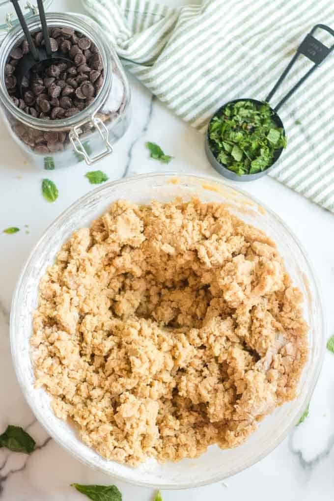 Cookie dough with chopped mint leaves and chocolate chips.