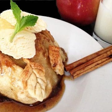 A plate of food on a table, with Apple dumpling