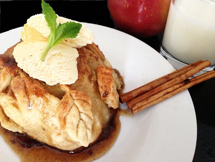 A plate of food on a table, with Apple dumpling 