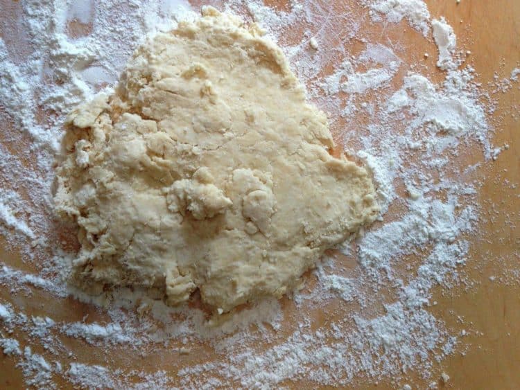 Homemade pastry dough on a floured cutting board