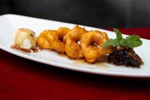 A plate of food on a table, with Picarones and Sweet potato