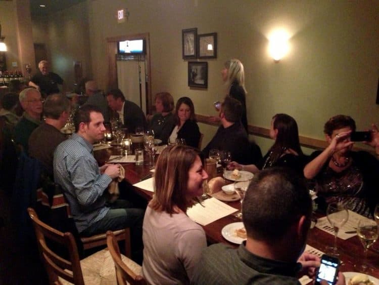 A group of people sitting at a table in a restaurant