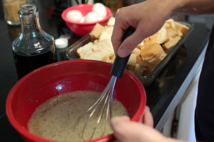 Whisking milk and eggs in a mixing bowl