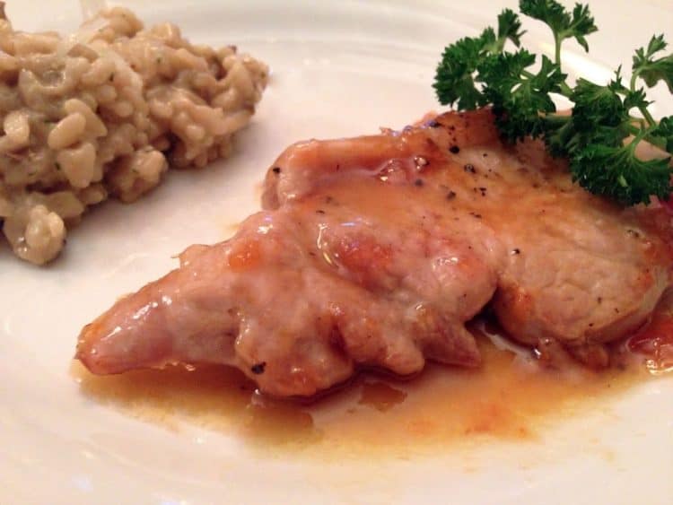 A close up of a plate of food, with Pork chops