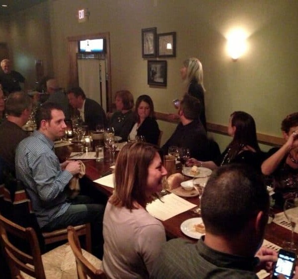 A group of people sitting at a table in a restaurant