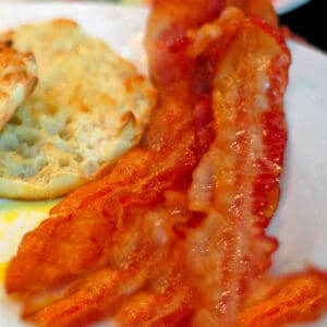 A few pieces of bacon with an English muffin
