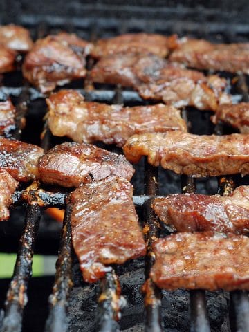 Strips of jerked beef on a grill