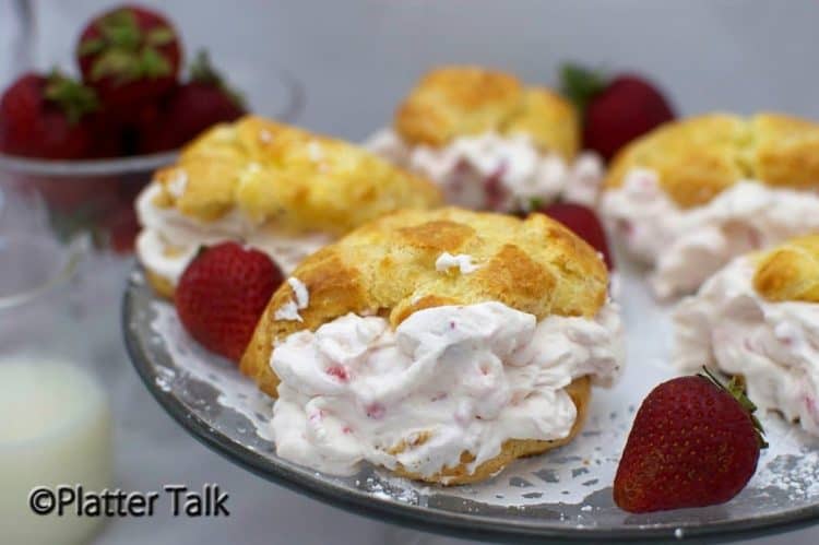 A platter of strawberry cream puffs with fresh strawberries