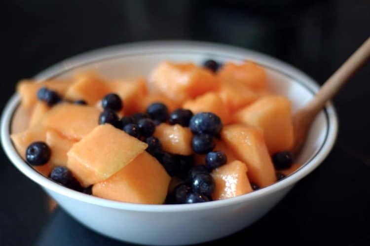 Blueberry and diced cantaloupe in bowl