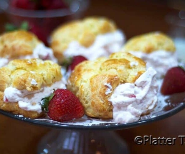 A plate of strawberry cream puffs