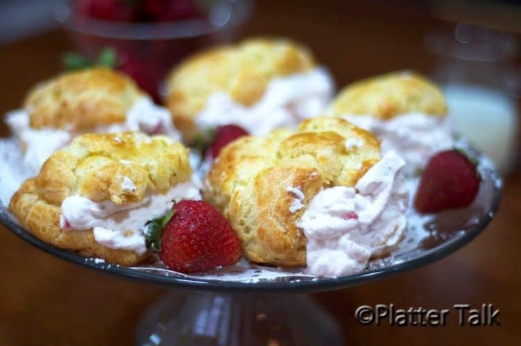 A plate of strawberry cream puffs