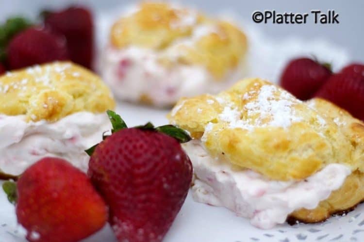 A plate of strawberry cream puffs