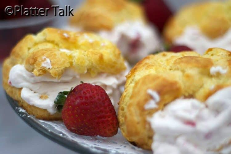 A close up of strawberry cream puffs