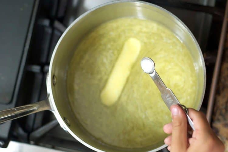 A saucepan with a melting stick of butter