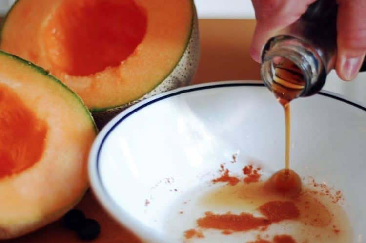 Someone pouring maple syrup in bowl, spit cantaloupe onboard