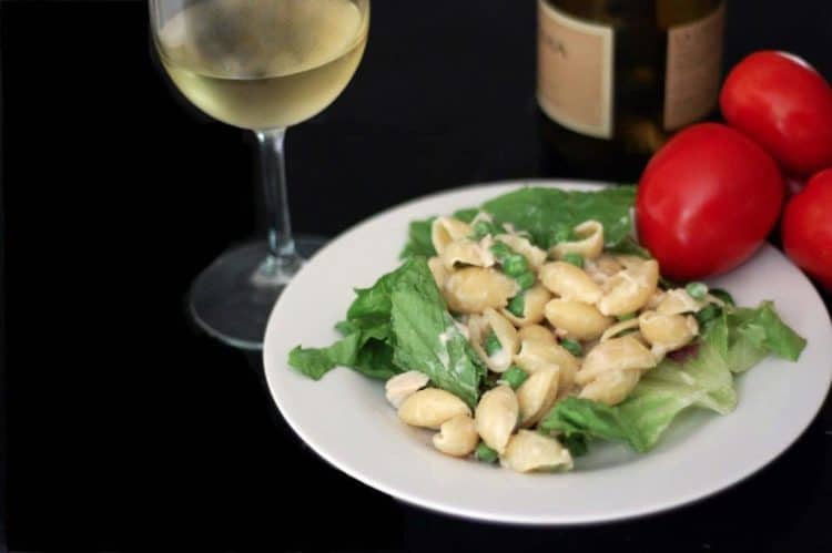 A plate of food and a glass of wine, with Salad