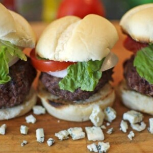 A trio of hamburger sliders filled with blue cheese.