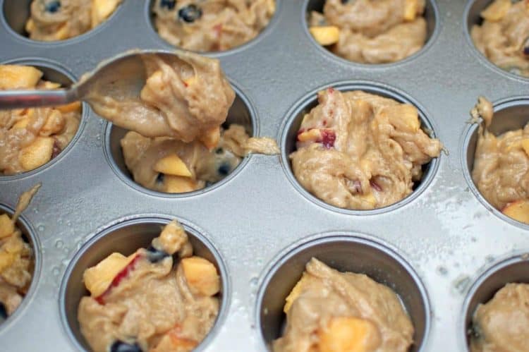 Scooping muffin batter into a muffin pan