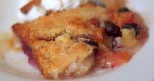 A close up of food on a plate, with Peach and Cobbler