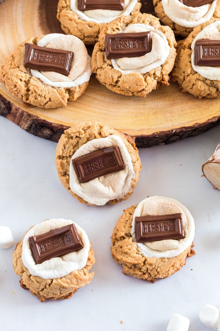 Group of cookies topped with marshmallows and chocolate bars.