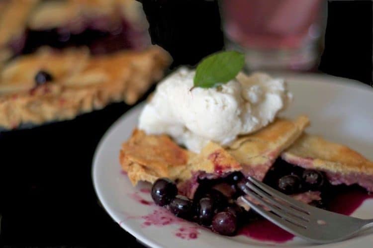 A slice of blueberry pie on a plate