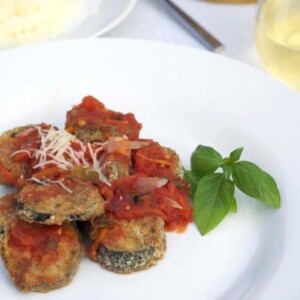 A plate of food with baked eggplant.