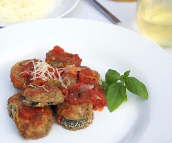 A plate of food with baked eggplant.