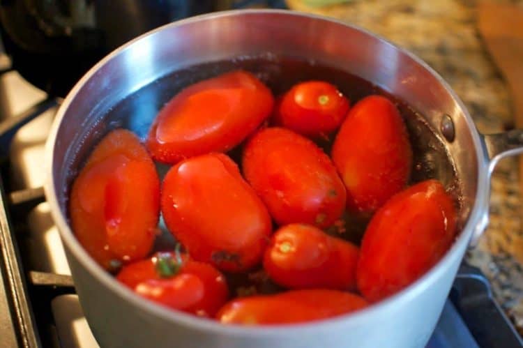 A pot of Roma tomatoes in water