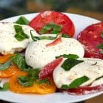 A plate of  Burrata and Caprese salad