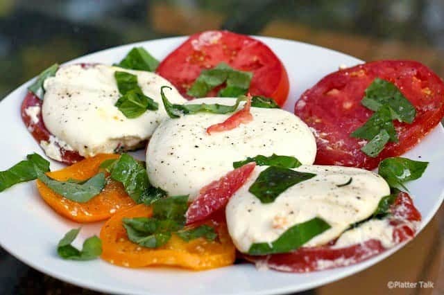 A plate of  Burrata and Caprese salad