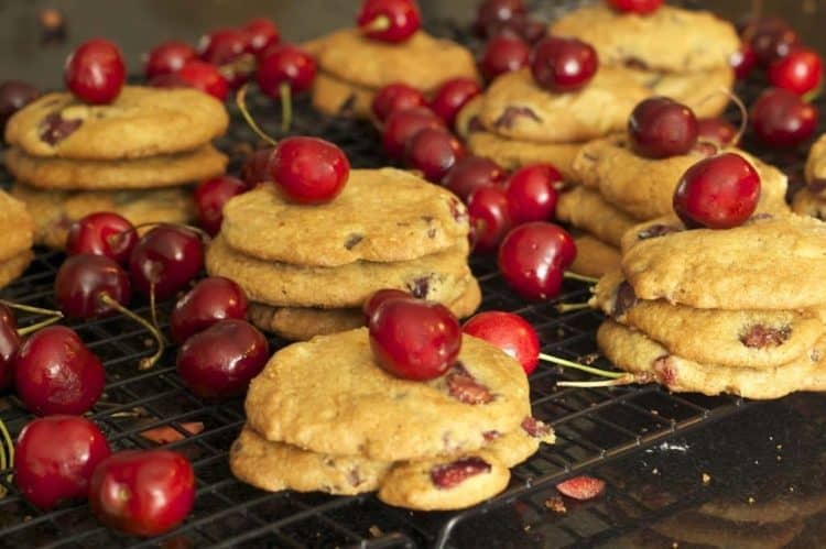 Stacks of cookies with cherries on a cooling rack