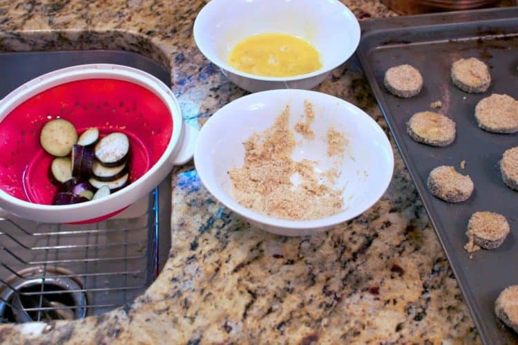 Dredging eggplant in breadcrumbs and egg