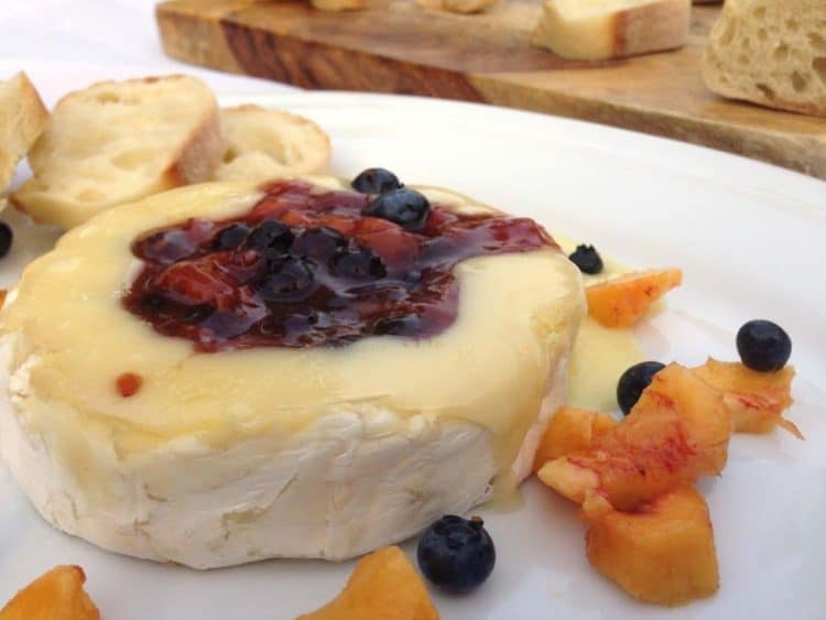 A plate of food on a table, with Brie and Bread