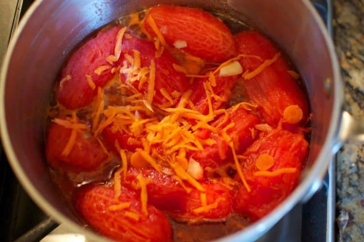A closeup of Roma tomatoes in a pot