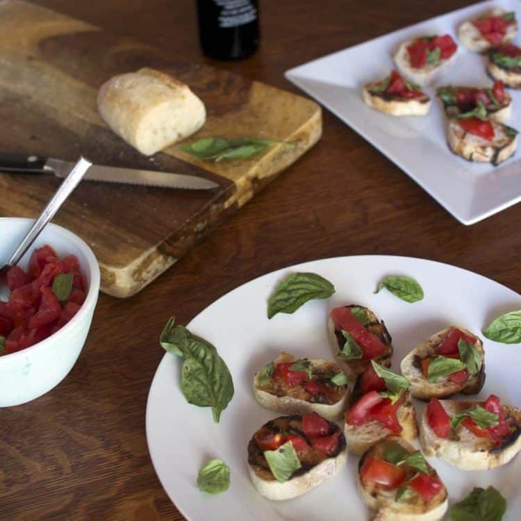 A plate of food on a table, with Bruschetta and Tomato