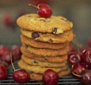 A stack of cookies with bing cherries